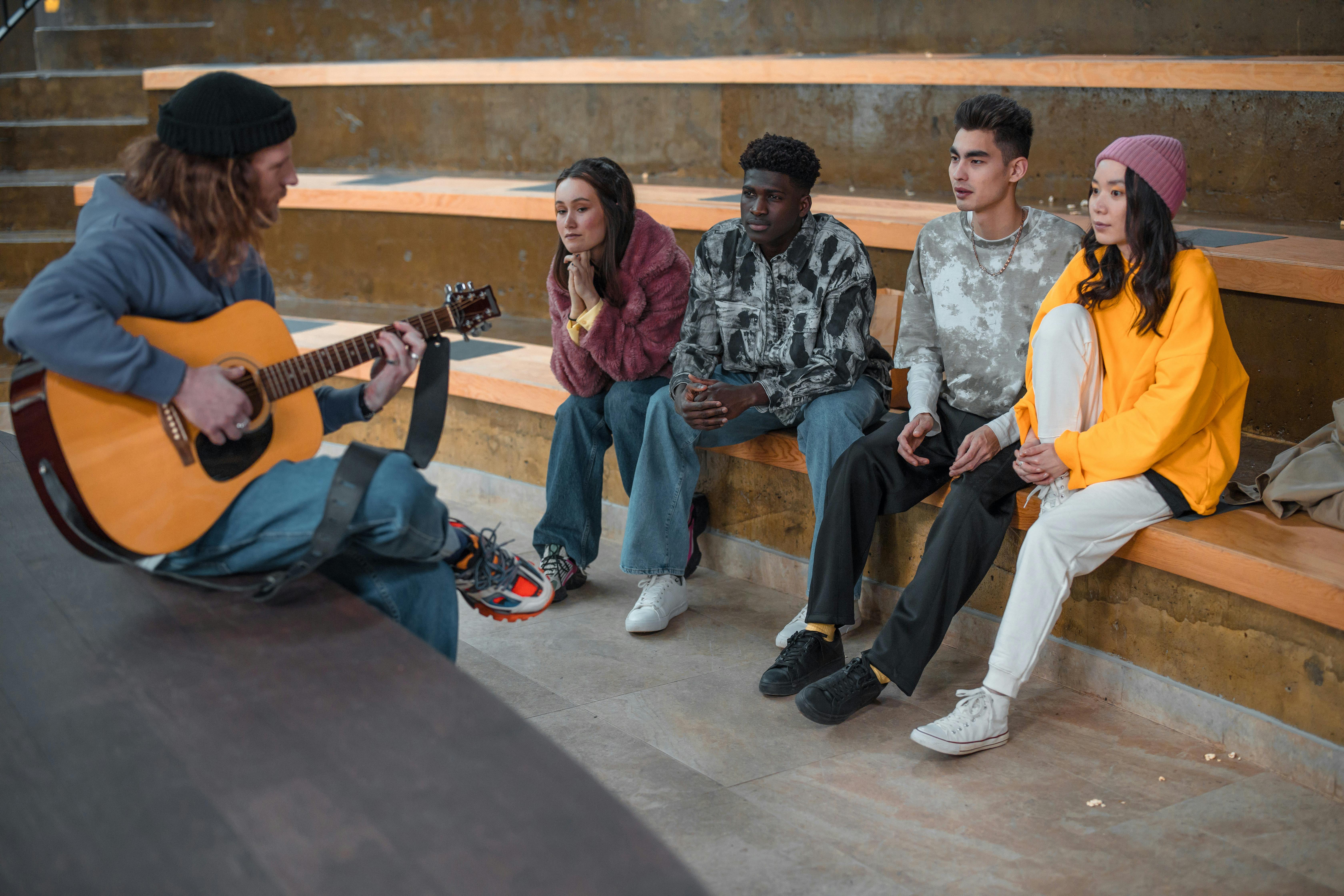 Student with electric guitar, beaming