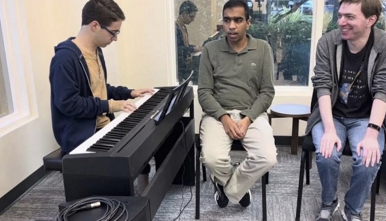 Students making music together at the piano